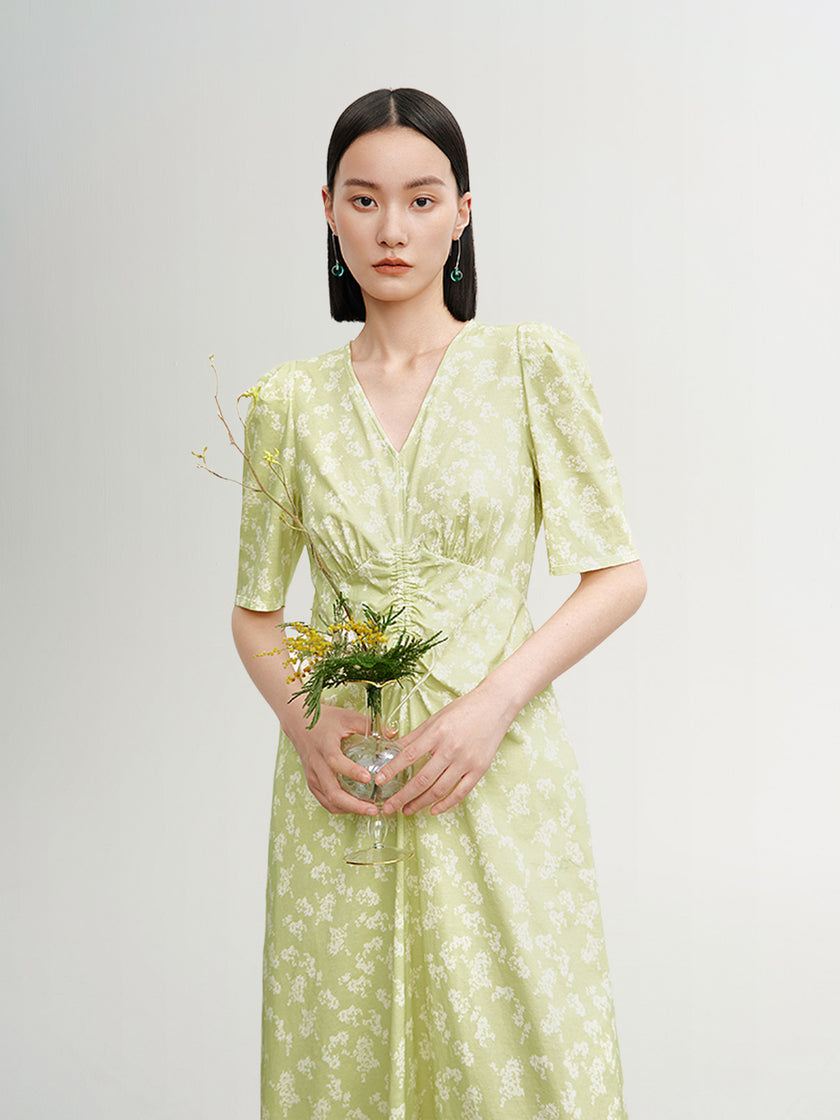 Green floral print dress with V-neck and pleated design