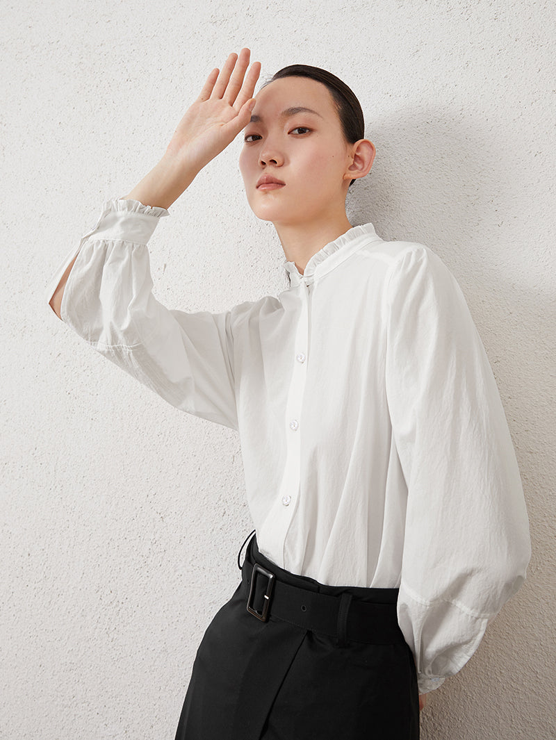 White long-sleeved blouse with pleated collar
