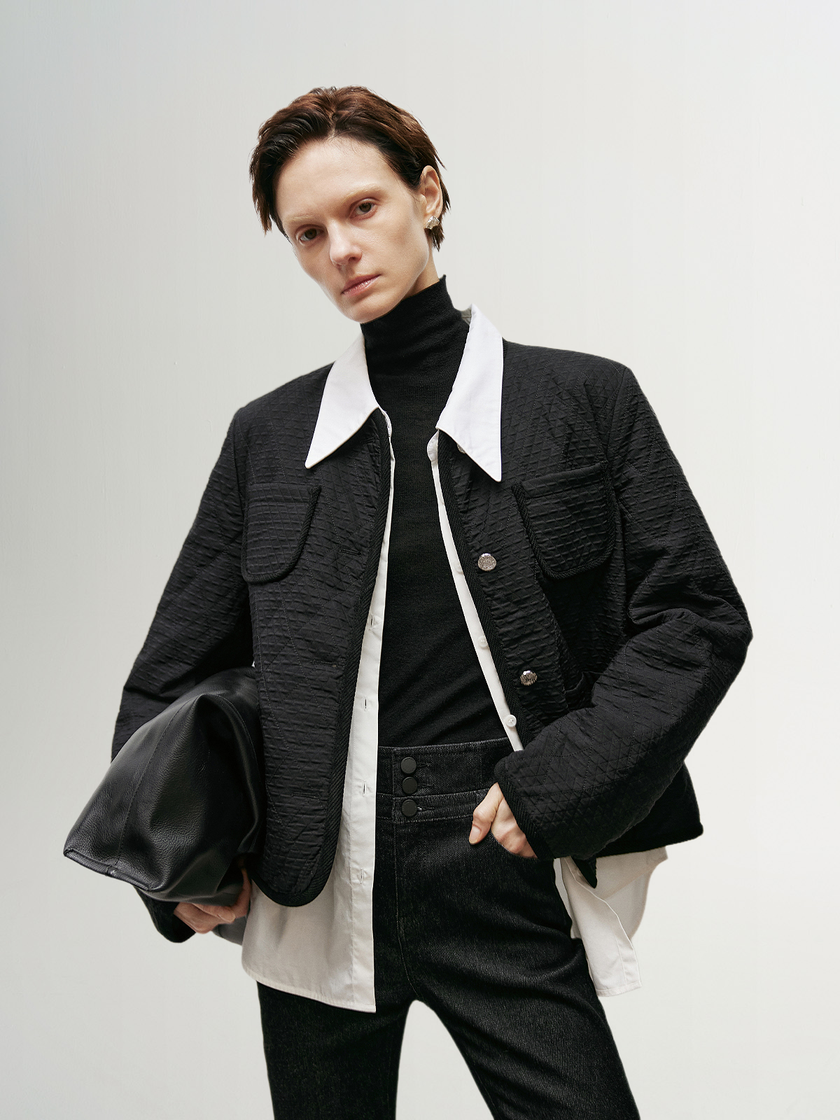 Black quilted jacket with round neck and buttons
