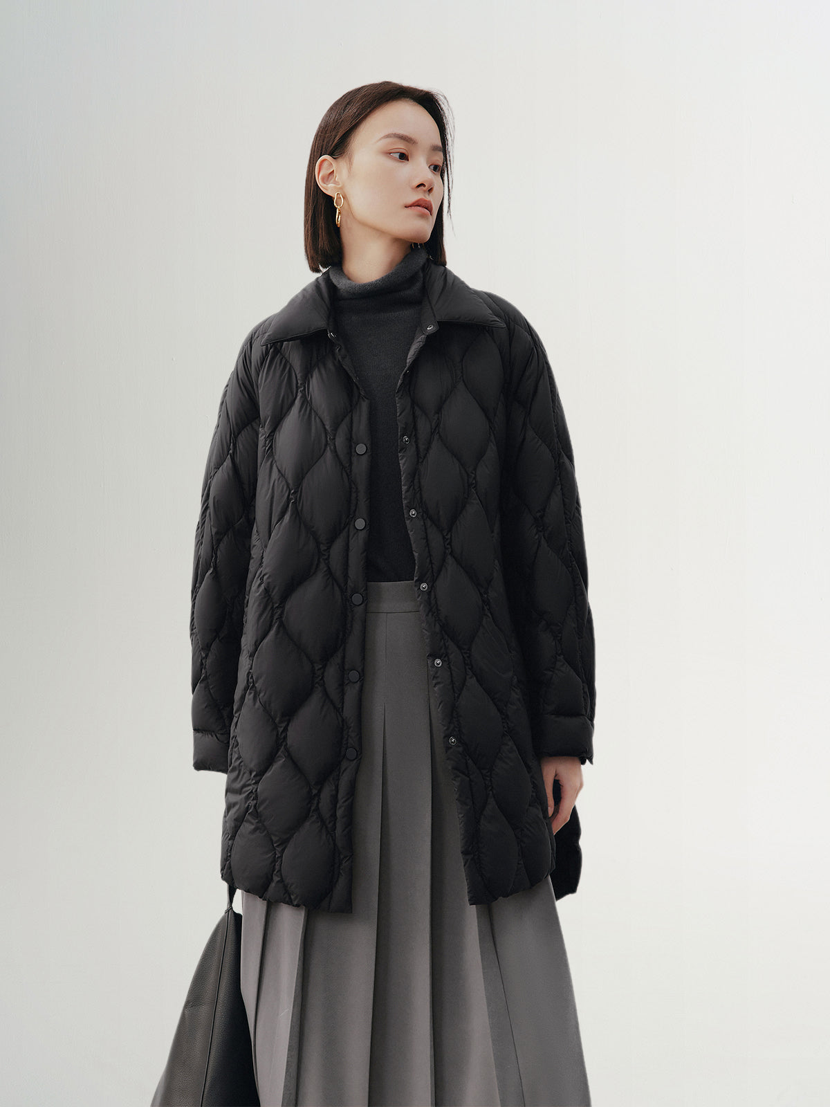 Black quilted hooded jacket with pattern