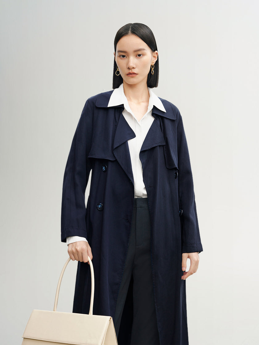 Navy blue mid-length trench coat with button fastening and belt