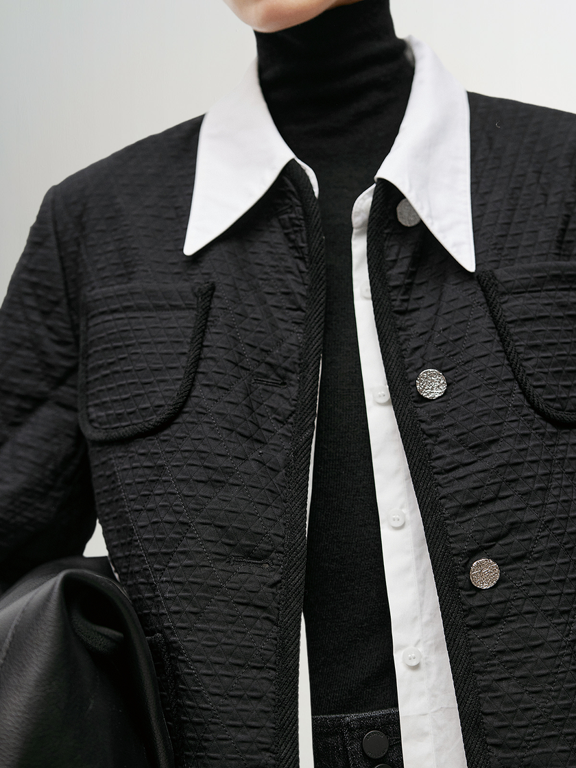 Black quilted jacket with round neck and buttons