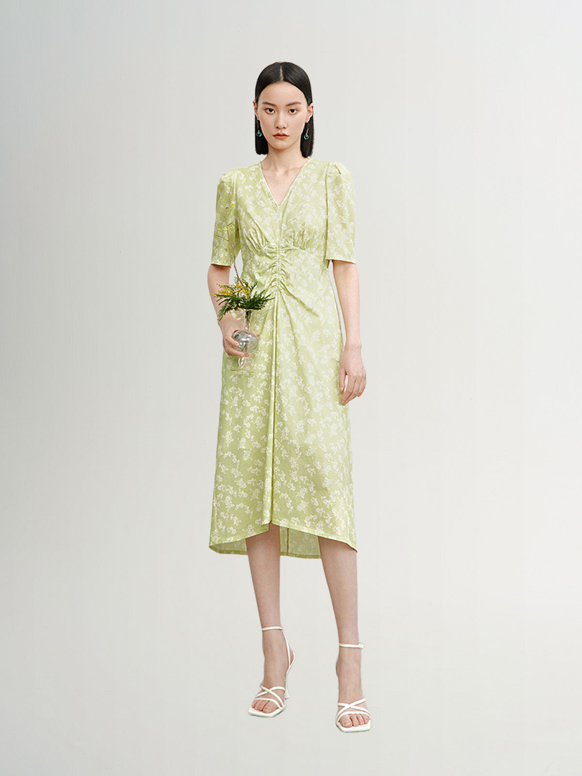 Green floral print dress with V-neck and pleated design