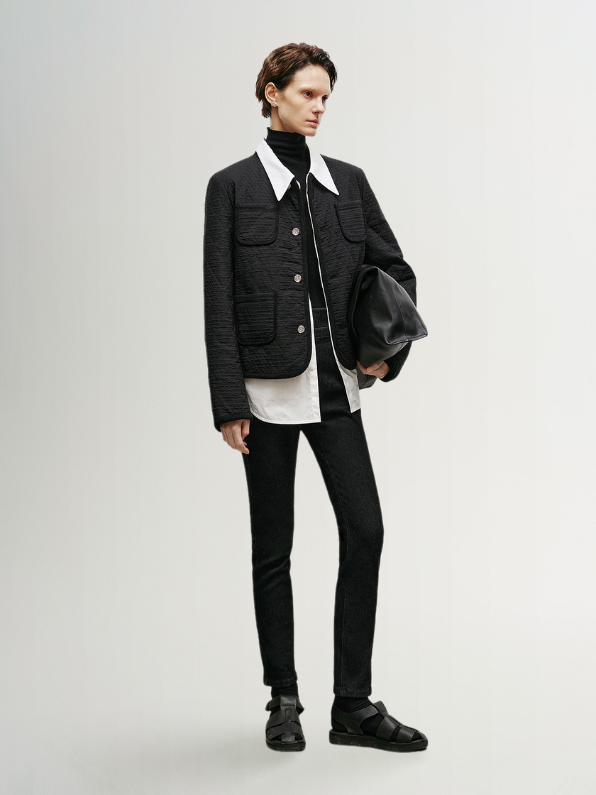 Black quilted jacket with round neck and buttons