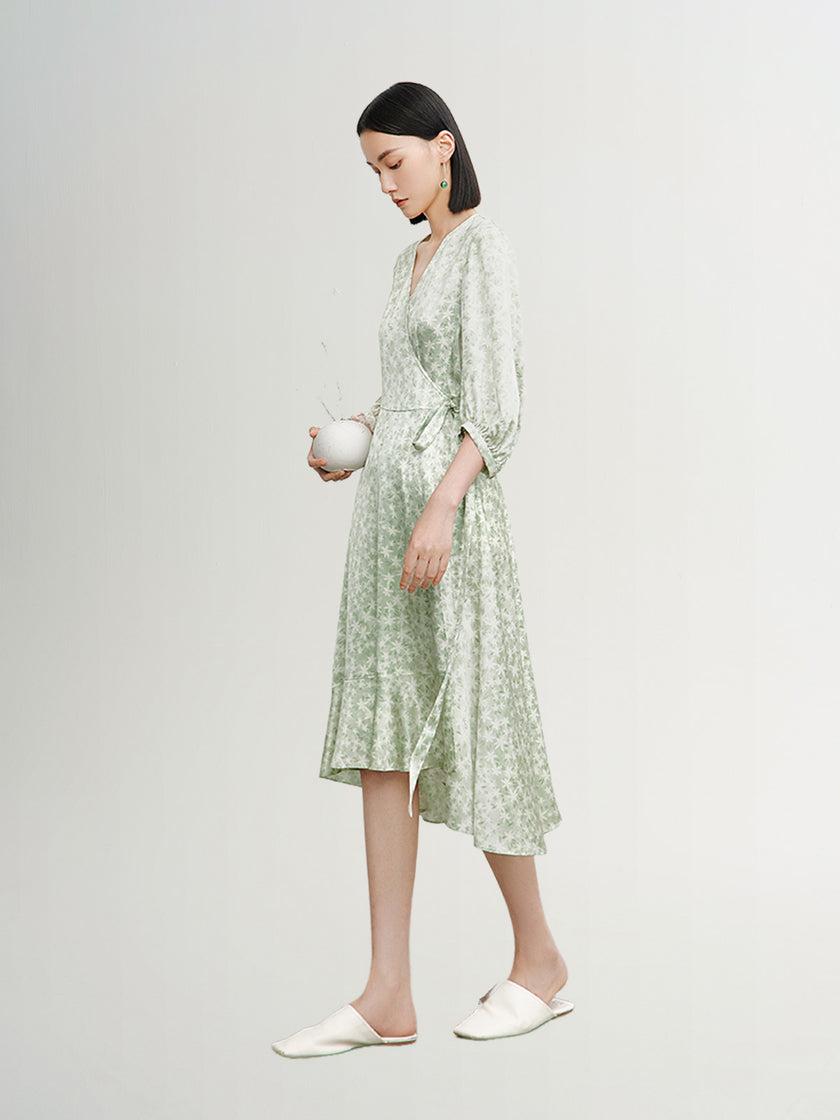 Mint green floral print dress with a v-neck, crossover cut and an irregular hem