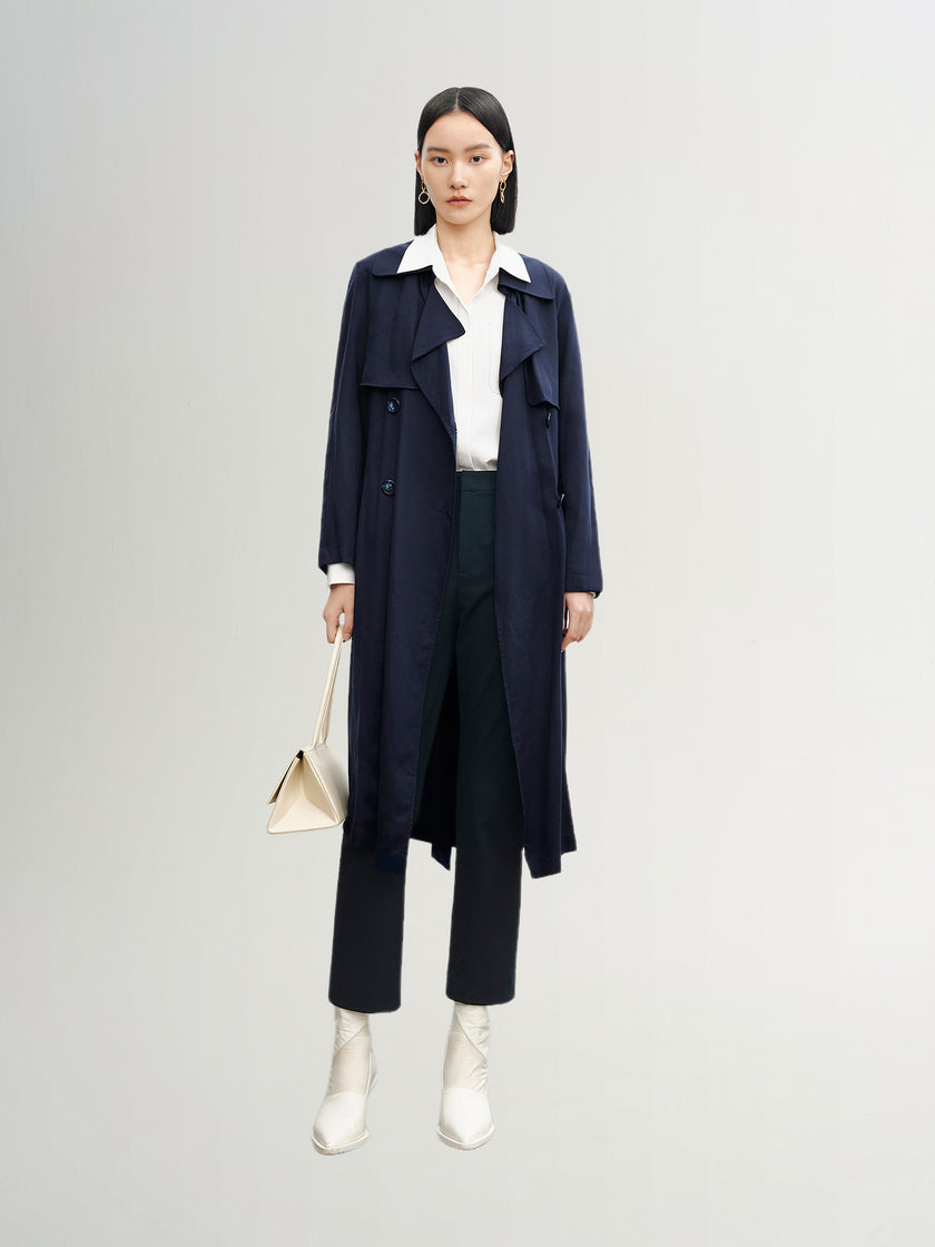 Navy blue mid-length trench coat with button fastening and belt