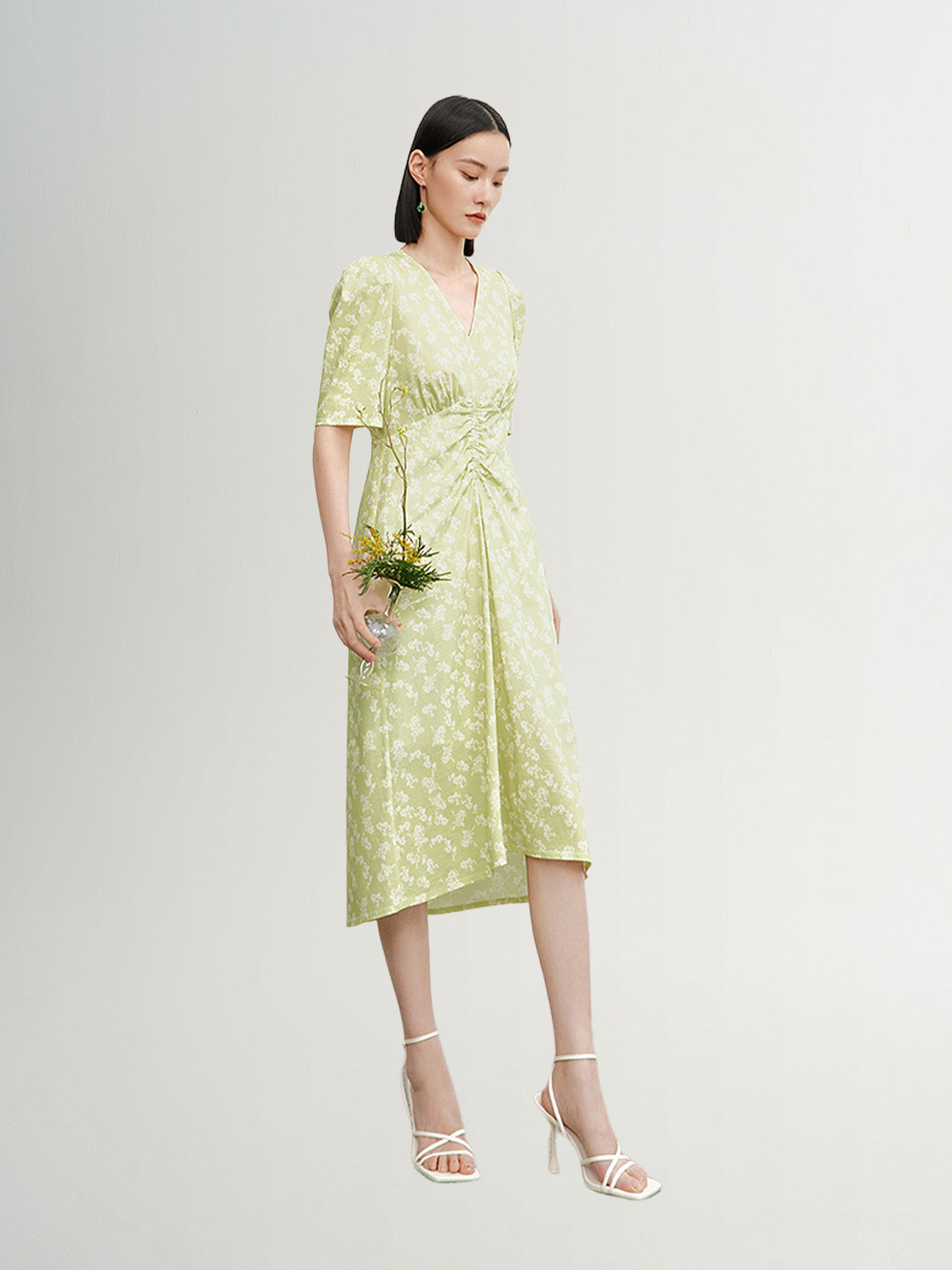 Green floral print dress with V-neck and pleated design