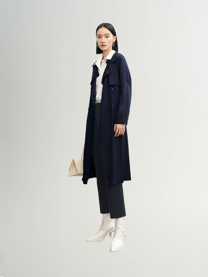 Navy blue mid-length trench coat with button fastening and belt