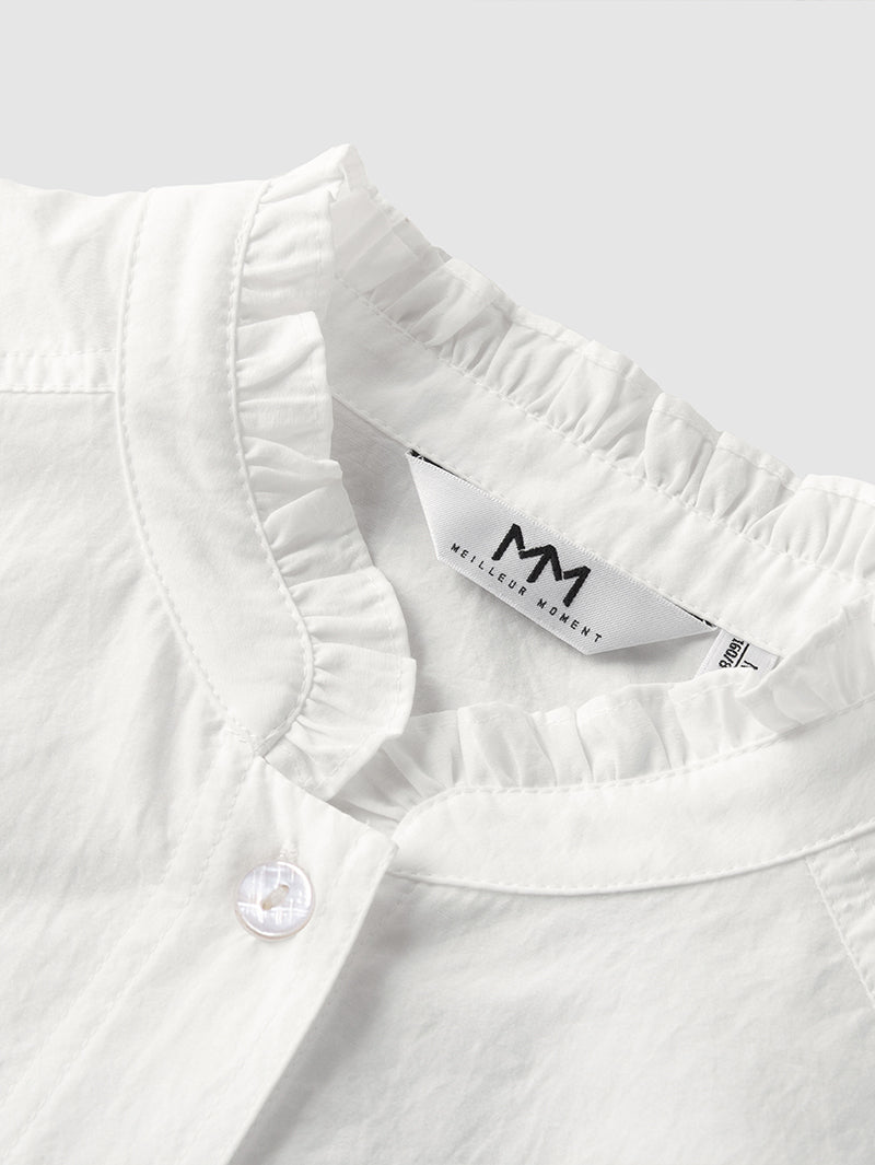 White long-sleeved blouse with pleated collar