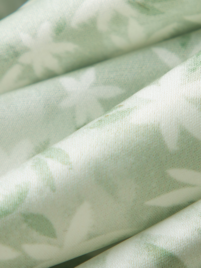 Mint green floral print dress with a v-neck, crossover cut and an irregular hem