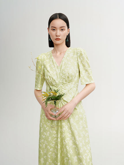 Green floral print dress with V-neck and pleated design