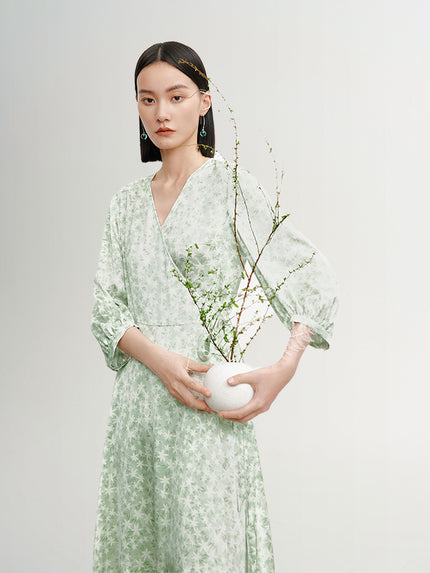 Mint green floral print dress with a v-neck, crossover cut and an irregular hem