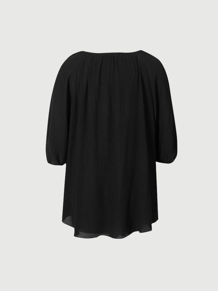 Blouse en soie noire à col rond et manches courtes