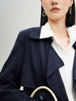 Navy blue mid-length trench coat with button fastening and belt