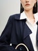 Navy blue mid-length trench coat with button fastening and belt
