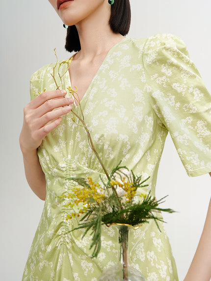 Green floral print dress with V-neck and pleated design