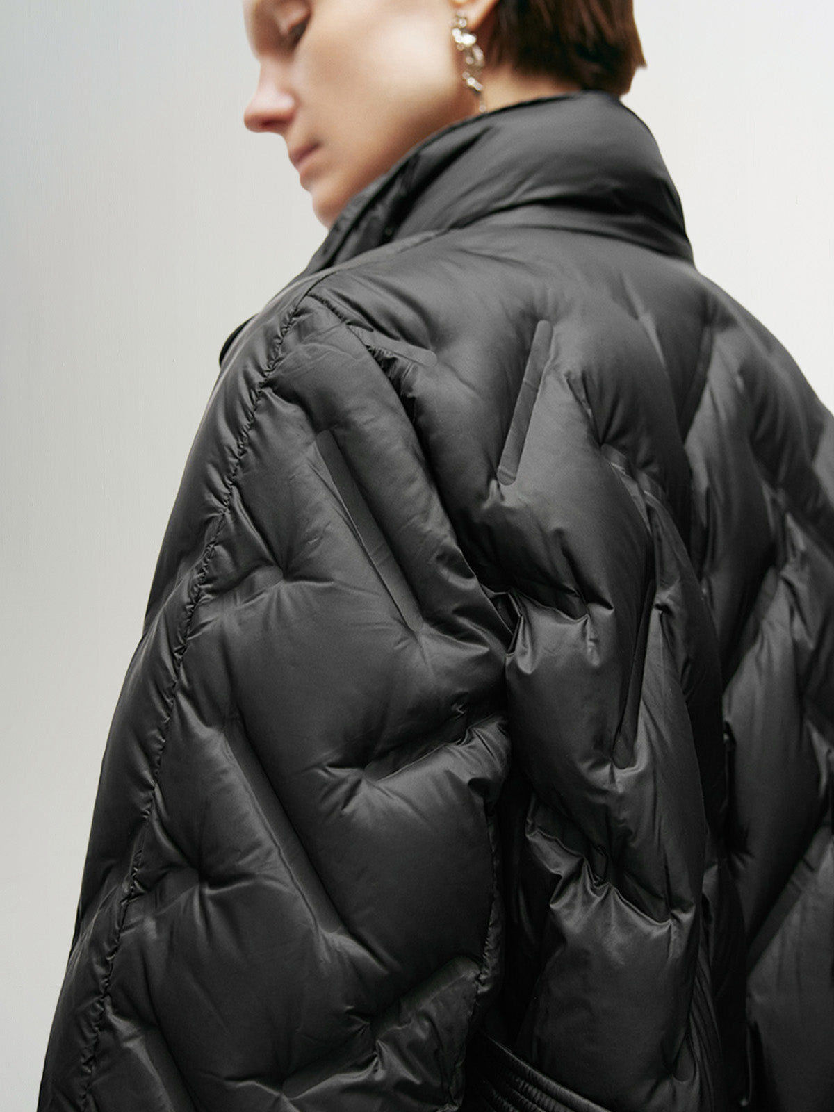 Black mid-length down jacket with hood and belt