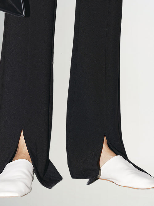 Load image 1 in gallery view. Black slim fit pants with a high waist and a slightly flared leg