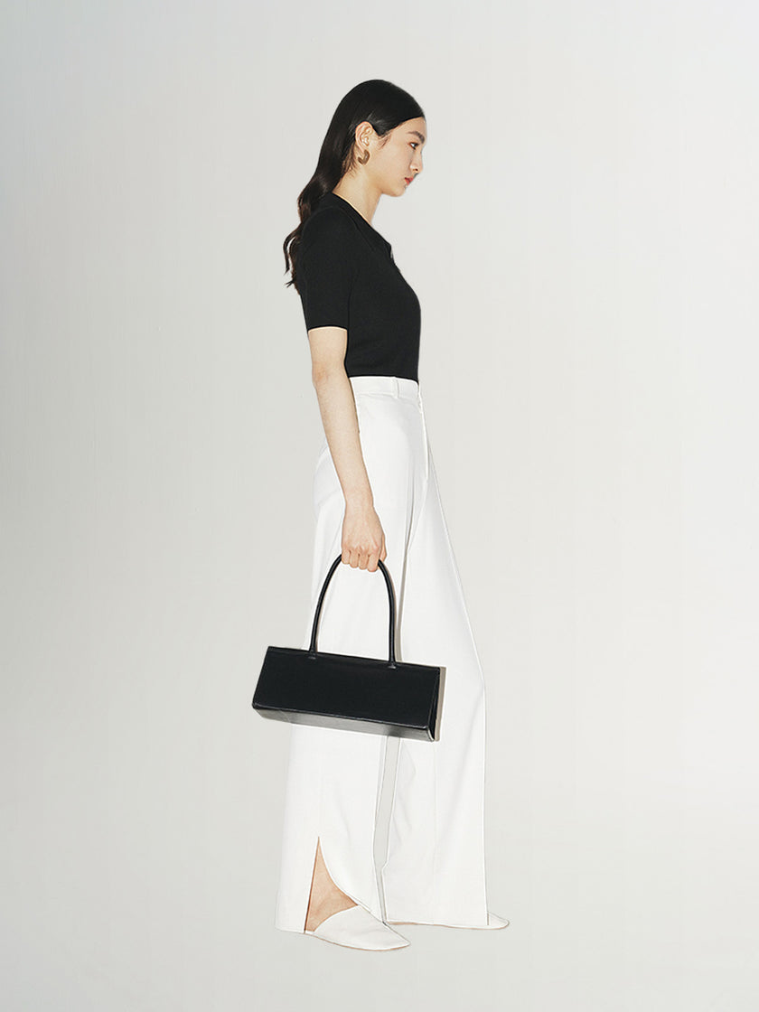 Top tricoté noir à col polo zippé, manches courtes