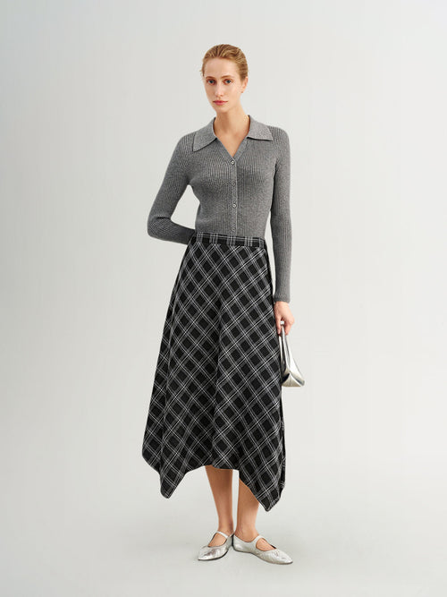 Load image 1 in gallery view. Woman wearing a gray sweater and plaid skirt on a white background