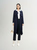 Navy blue mid-length trench coat with button fastening and belt