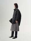 Black quilted hooded jacket with pattern