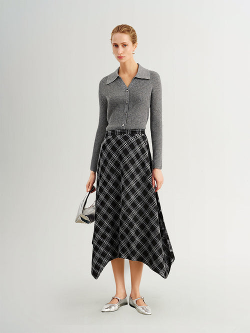 Load image 1 in gallery view. Woman wearing a gray sweater and black plaid skirt on a white background
