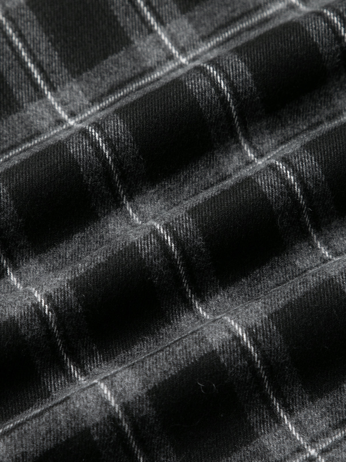 Close-up of a textured black surface with geometric patterns
