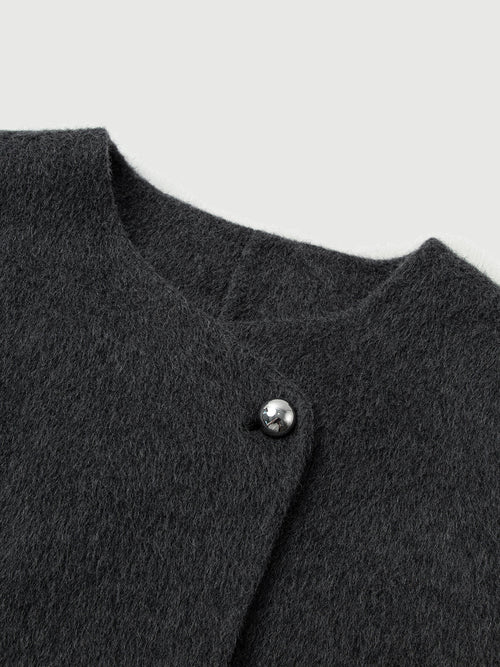 Charger l'image 1 dans la galerie. Close-up of a dark gray textured garment with a button